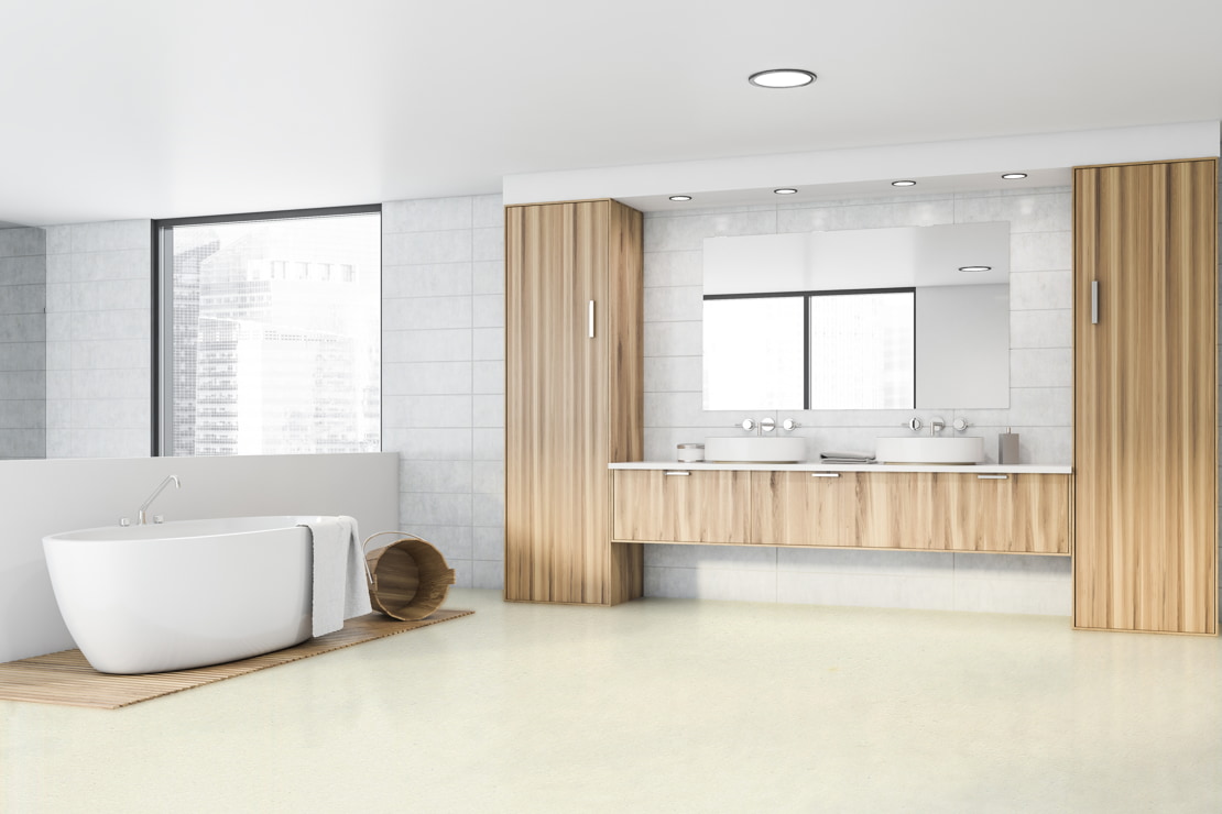 Minimalist style bathroom with micro-cement floors, freestanding bathtub and wooden finishes around the double washbasin
